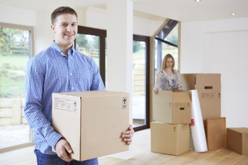 Loading office furniture into a moving vehicle during an Ilford relocation