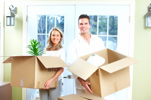 Removal team handling furniture in an Ilford property