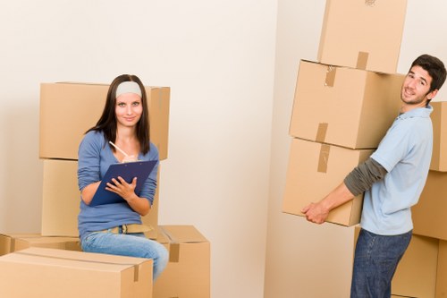 Removal team handling boxes and furniture in Ilford